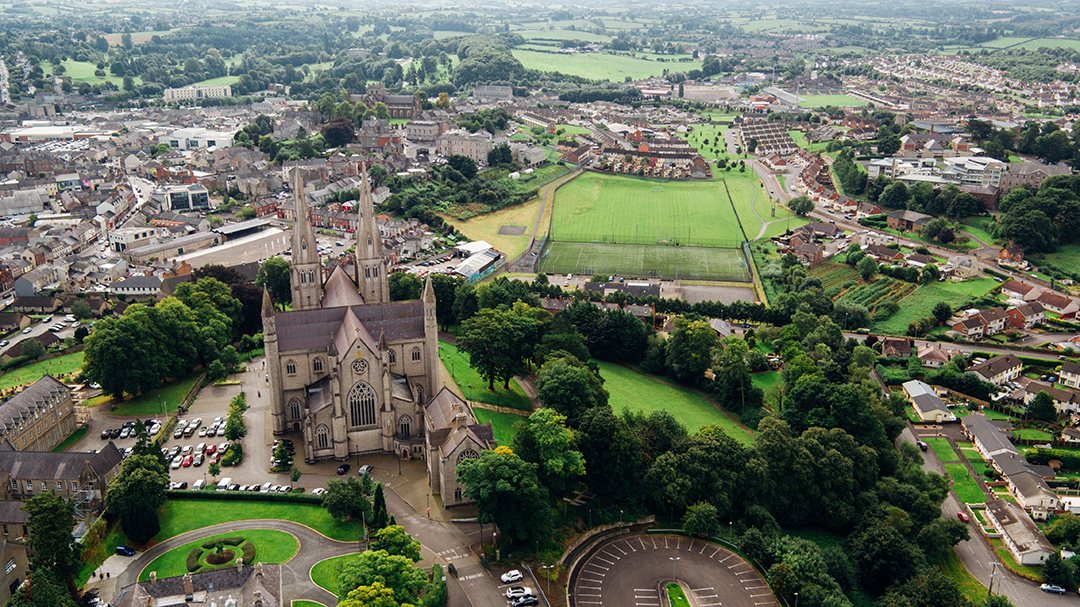 An aerial view of the twin-spired Roman Catholic Cathedral of Saint Patrick and the green surroundings of Armagh in Northern Ireland.