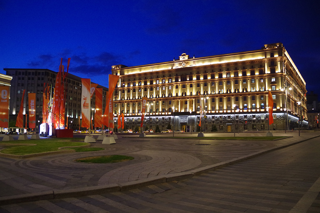 A grand Moscow building illuminated at night, showcasing the city’s lively evening atmosphere.