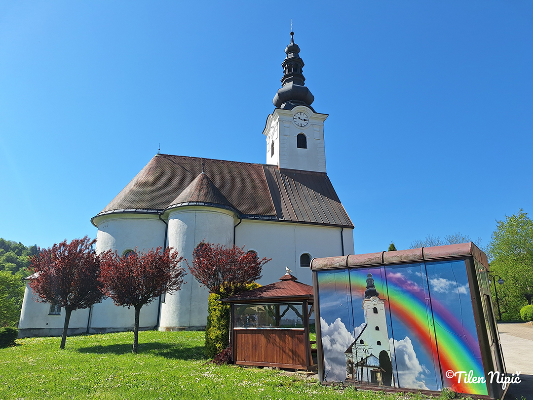 St. Cunigunde’s Church perched on a hill above the Svečina Hills, surrounded by vibrant colors and wide views.