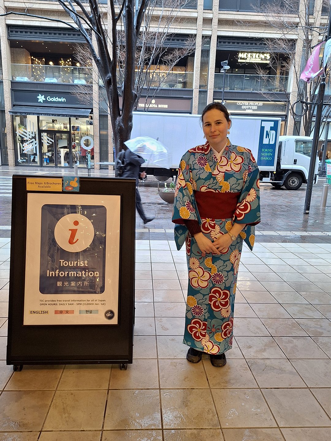 Traveller wearing a traditional Japanese kimono at a tourist information center in Tokyo, where visitors can learn about local culture and experience a small part of Japanese traditions.
