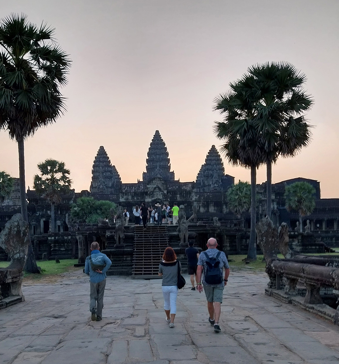 Sunrise at Angkor Wat, with visitors gathering to witness the silhouette of the world’s largest religious monument.